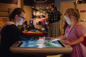 two children interacting with an exhibit at the Children's Museum