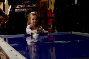 child playing air hockey