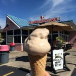 Peanut butter ice cream cone in front of local ice cream shop