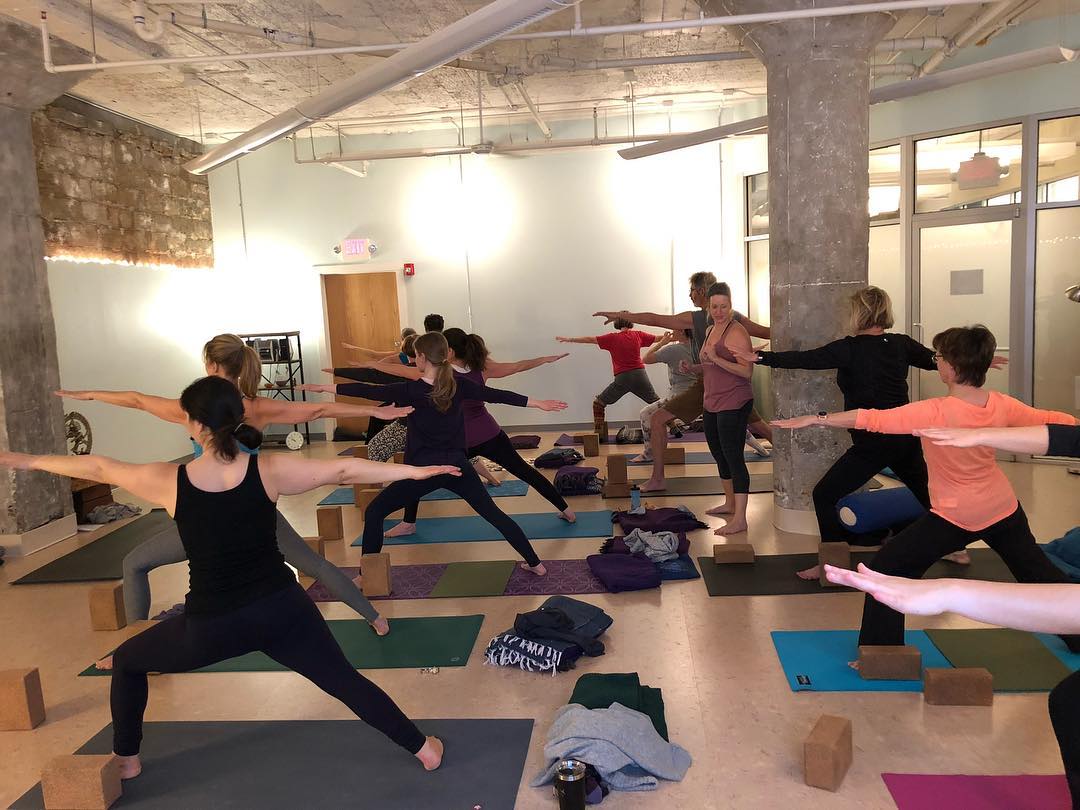 women at gym doing yoga poses