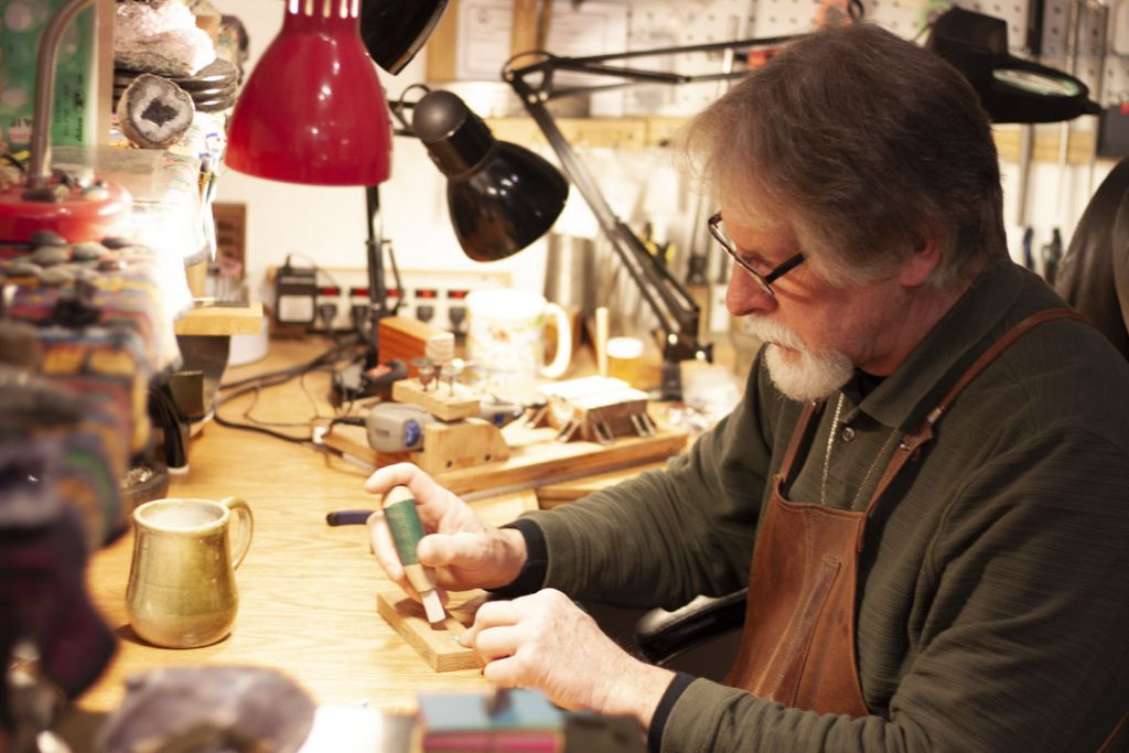 man at work using tools to shape rocks