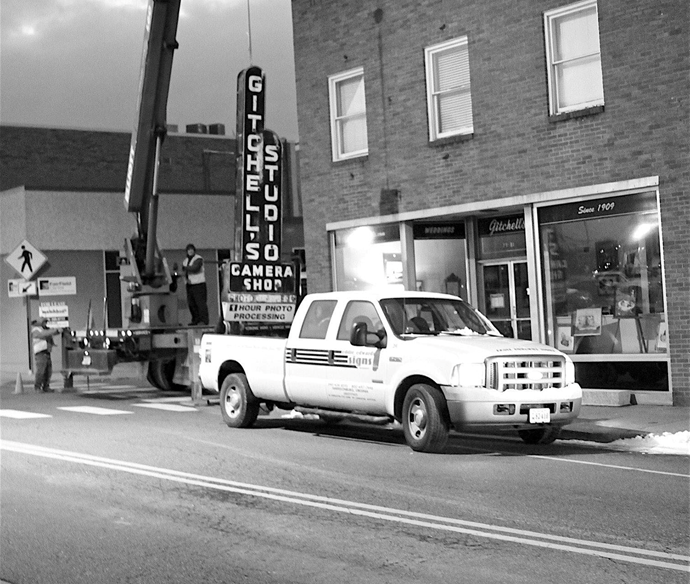 black and white photo of neon sign downtown