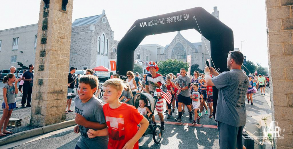 Families running in costumes at fourth of july event