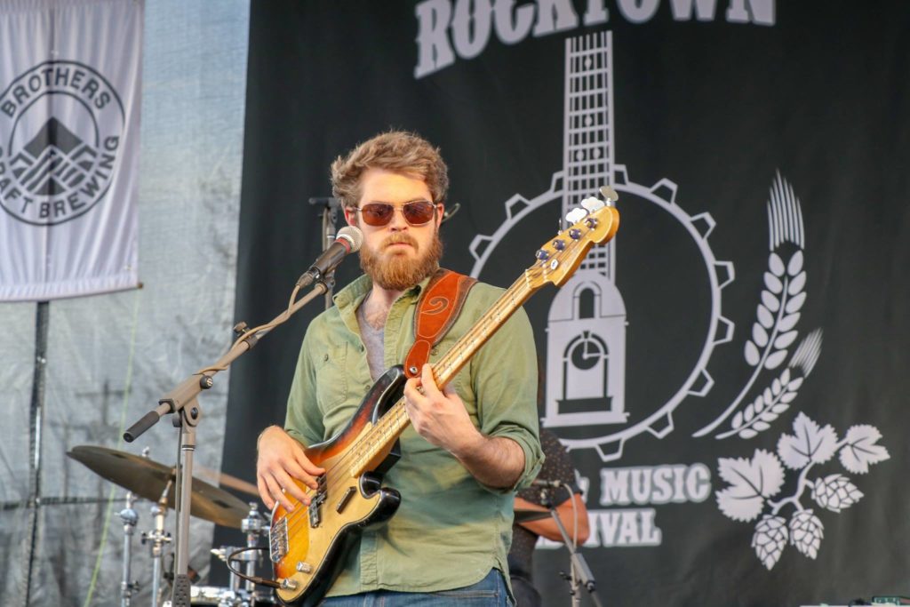 Man playing guitar on stage in downtown Harrisonburg