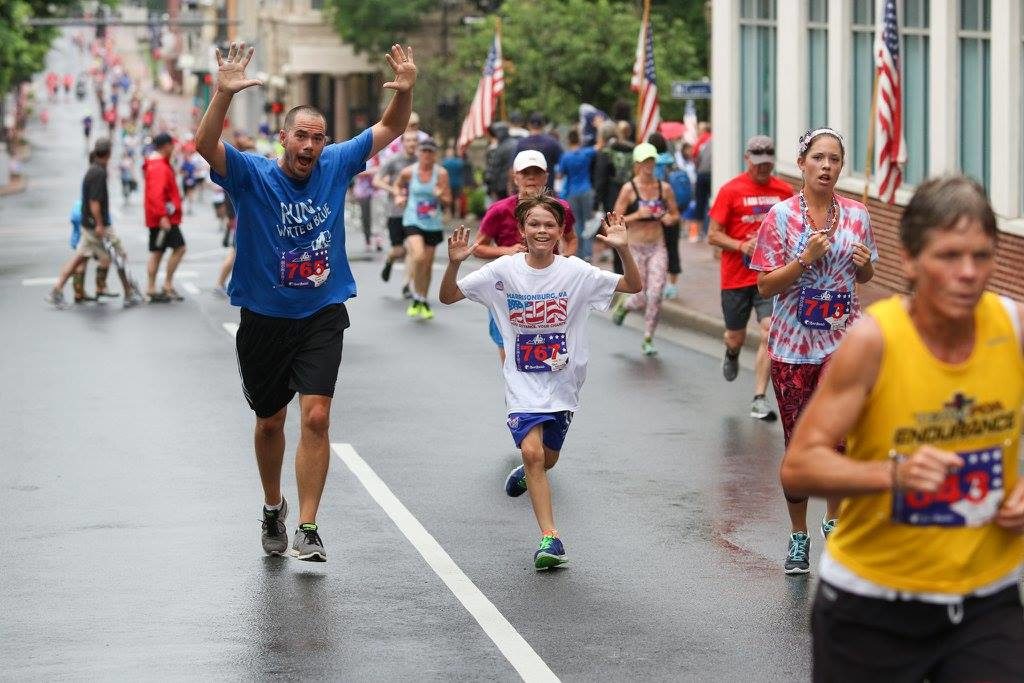 Happy people running marathon on rainy day