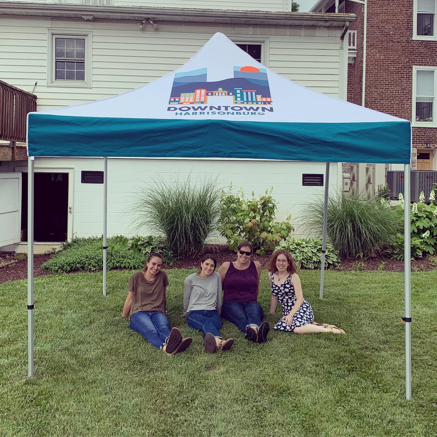 Happy coworkers under tent in Downtown Harrisonburg