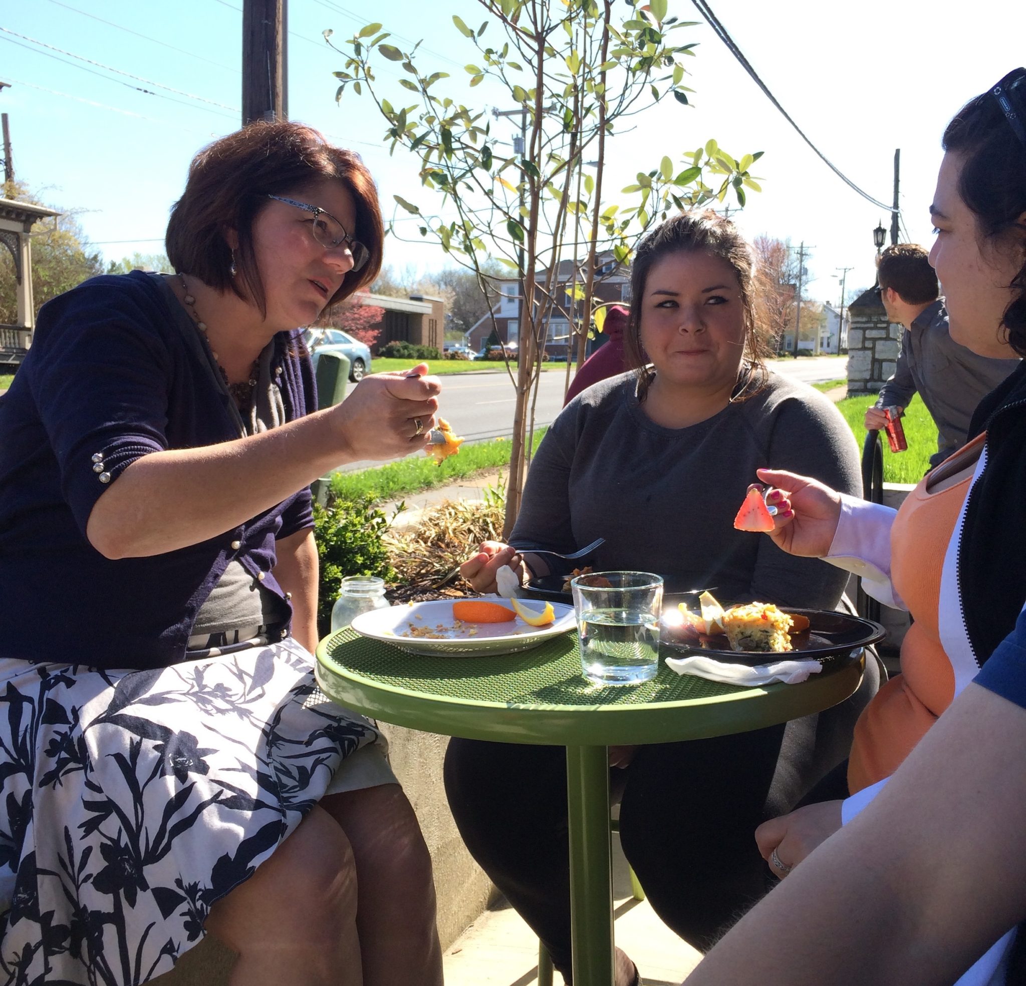 Coworkers eating breakfast outside