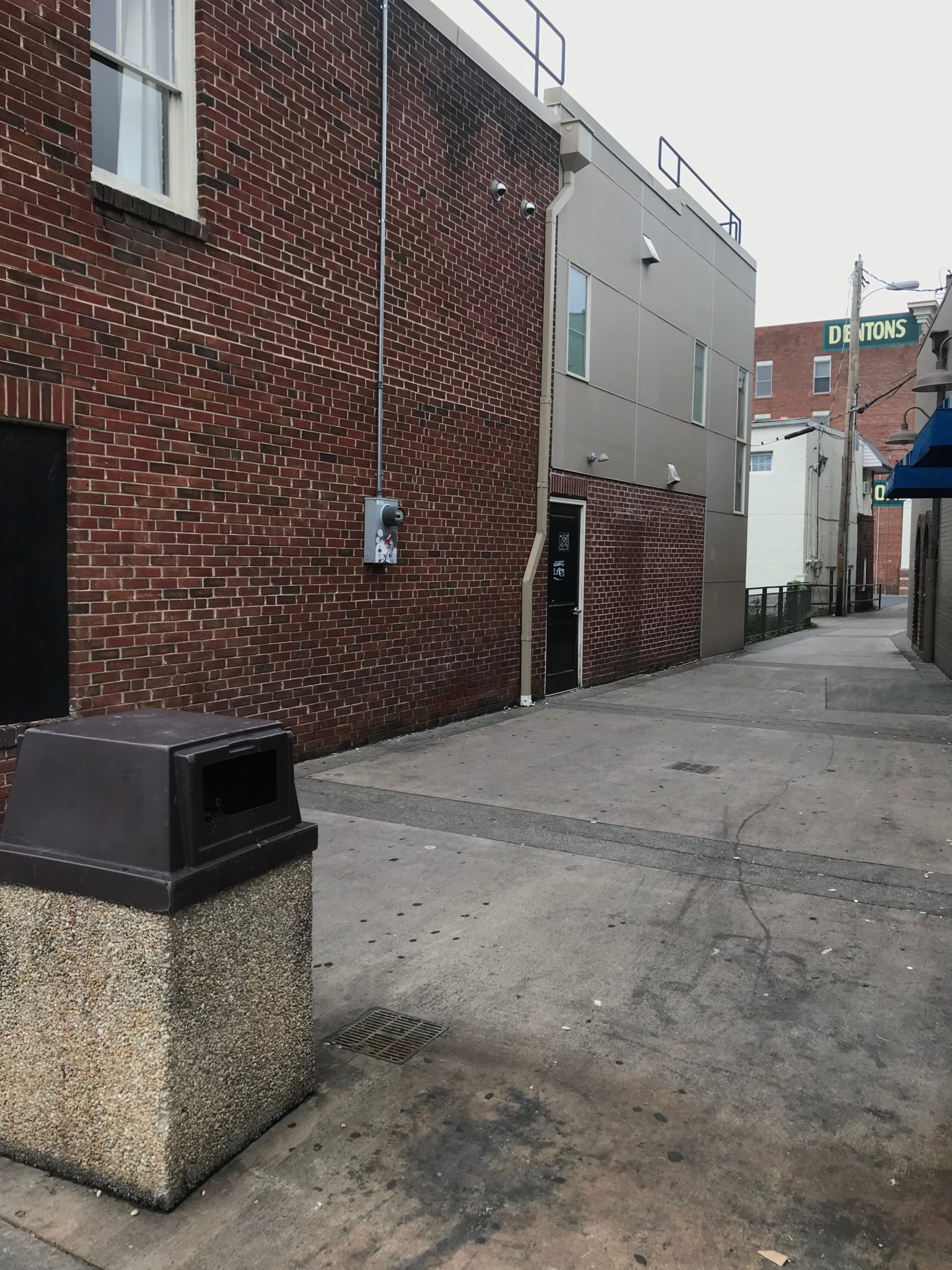 Alleyway with brick wall between Finnegan’s Cove and Beyond in Downtown Harrisonburg