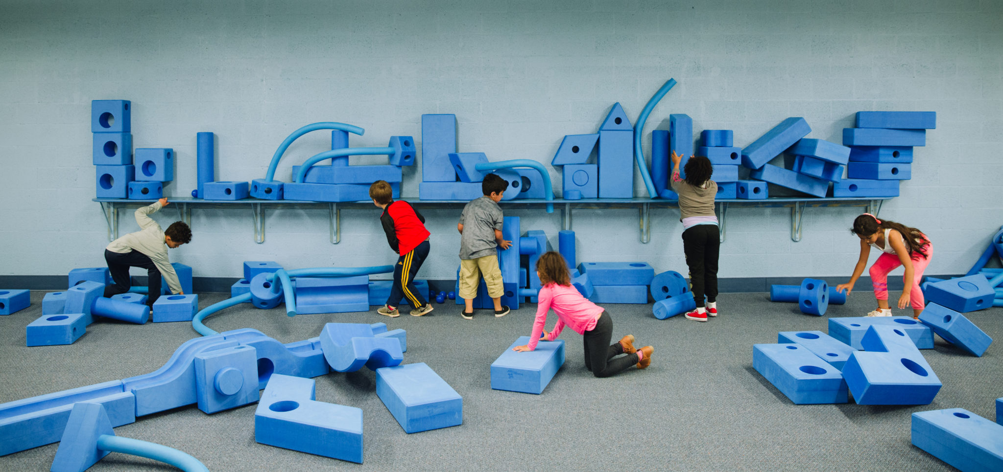 Children playing with blocks at children's museum exhibit