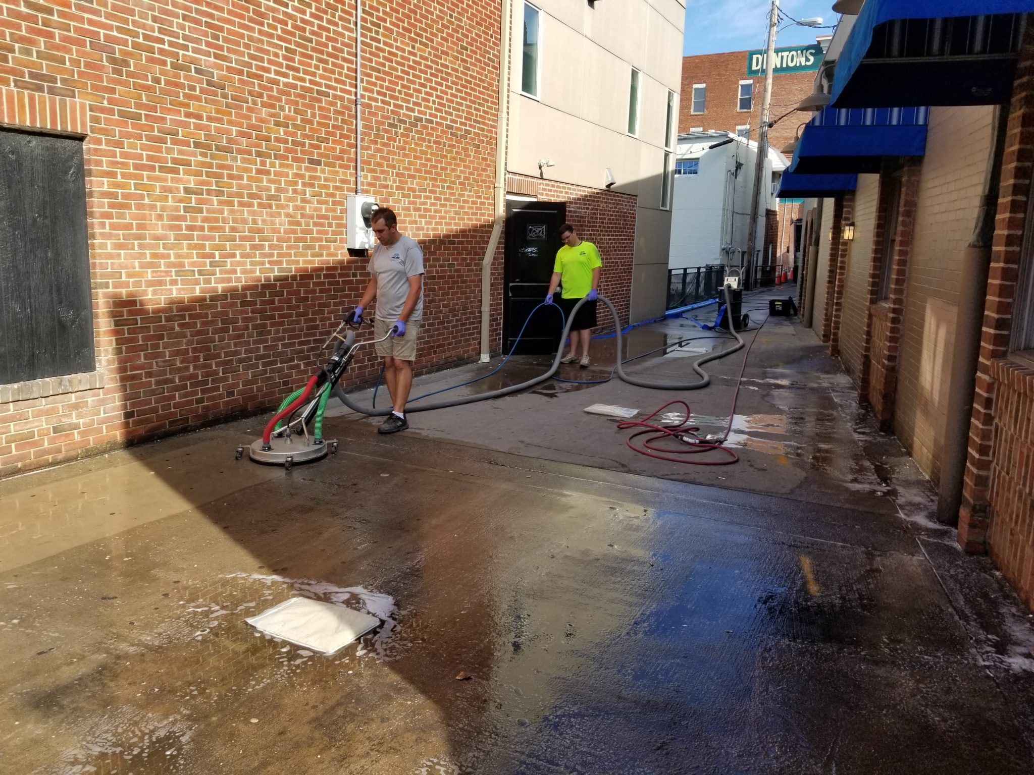 Men cleaning up an alley