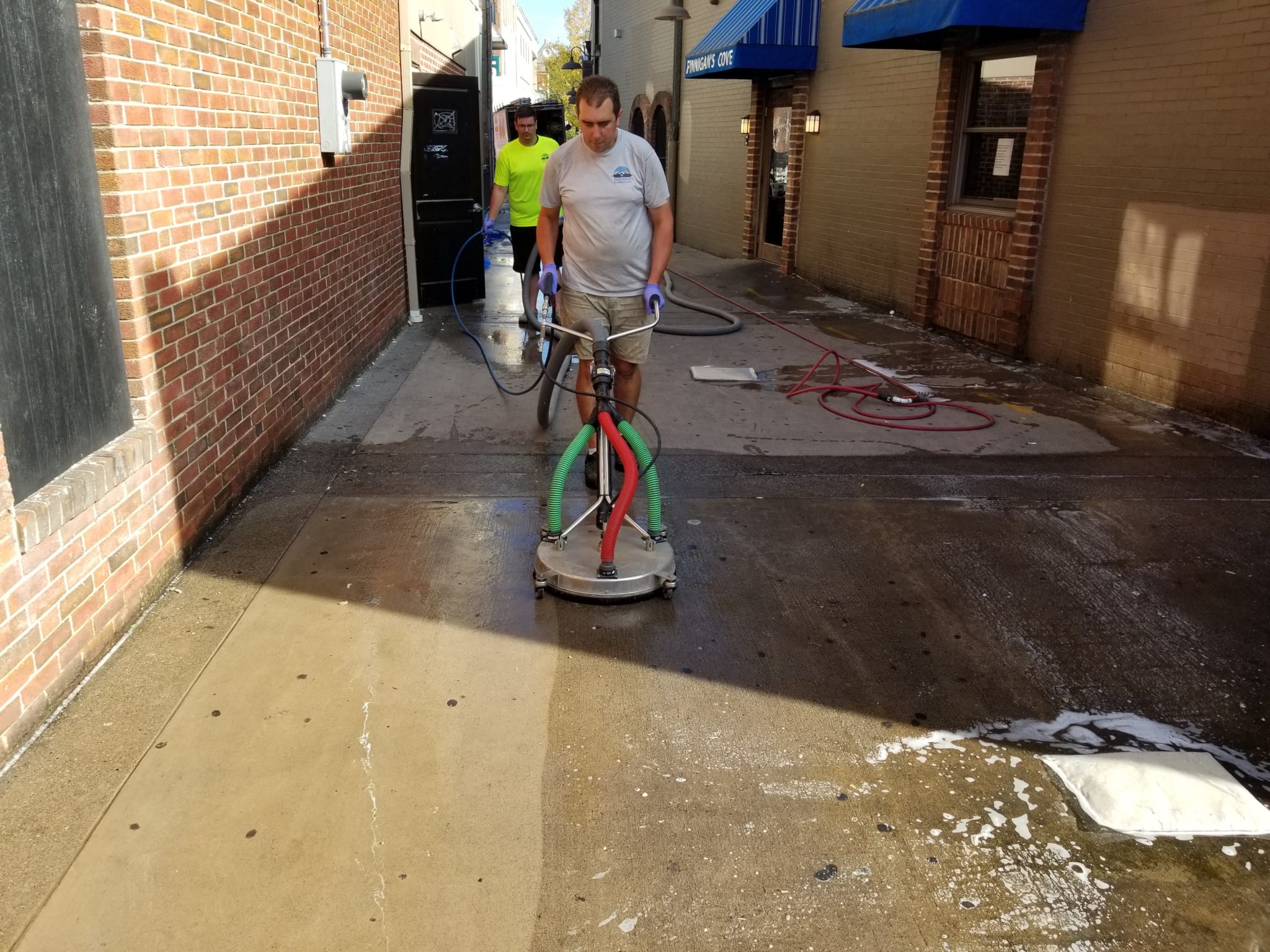 Men cleaning up an alleyway