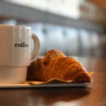 Coffee mug and croissant