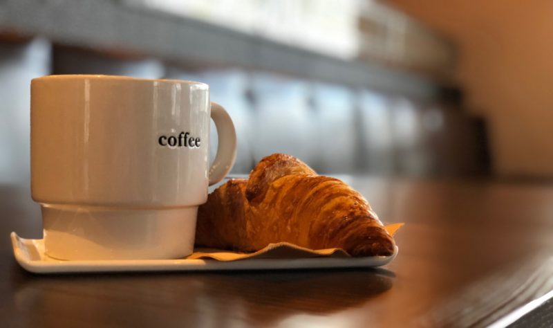 Coffee mug and croissant