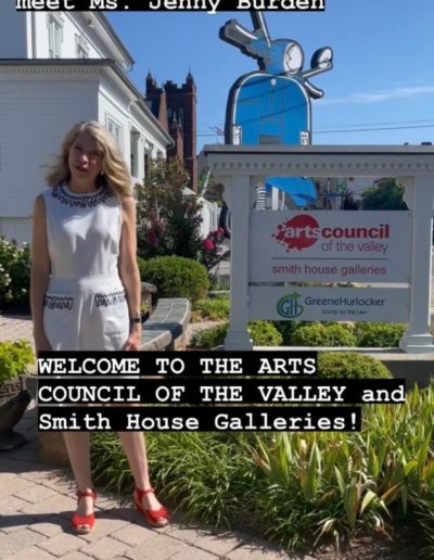 Jenny Burden outside Arts Council of the Valley's smith house galleries sign